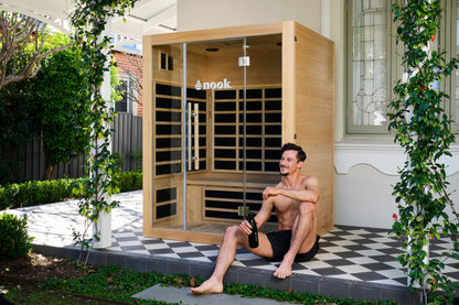 Individual infront of a Nook Elite 3-person infrared sauna