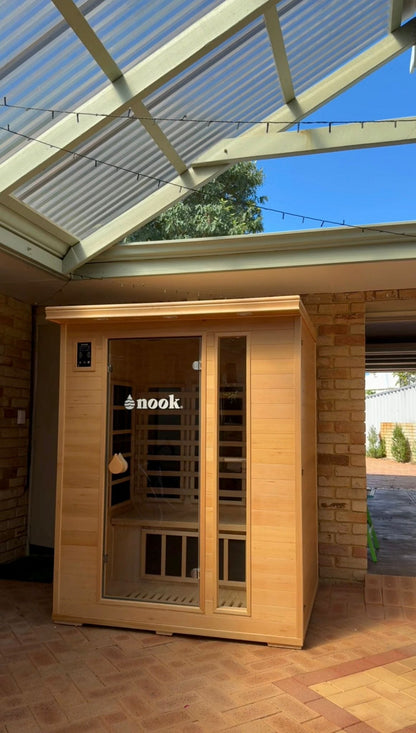 Nook Core 3-person infrared sauna in Canadian Hemlock, installed outdoors under a covered roof