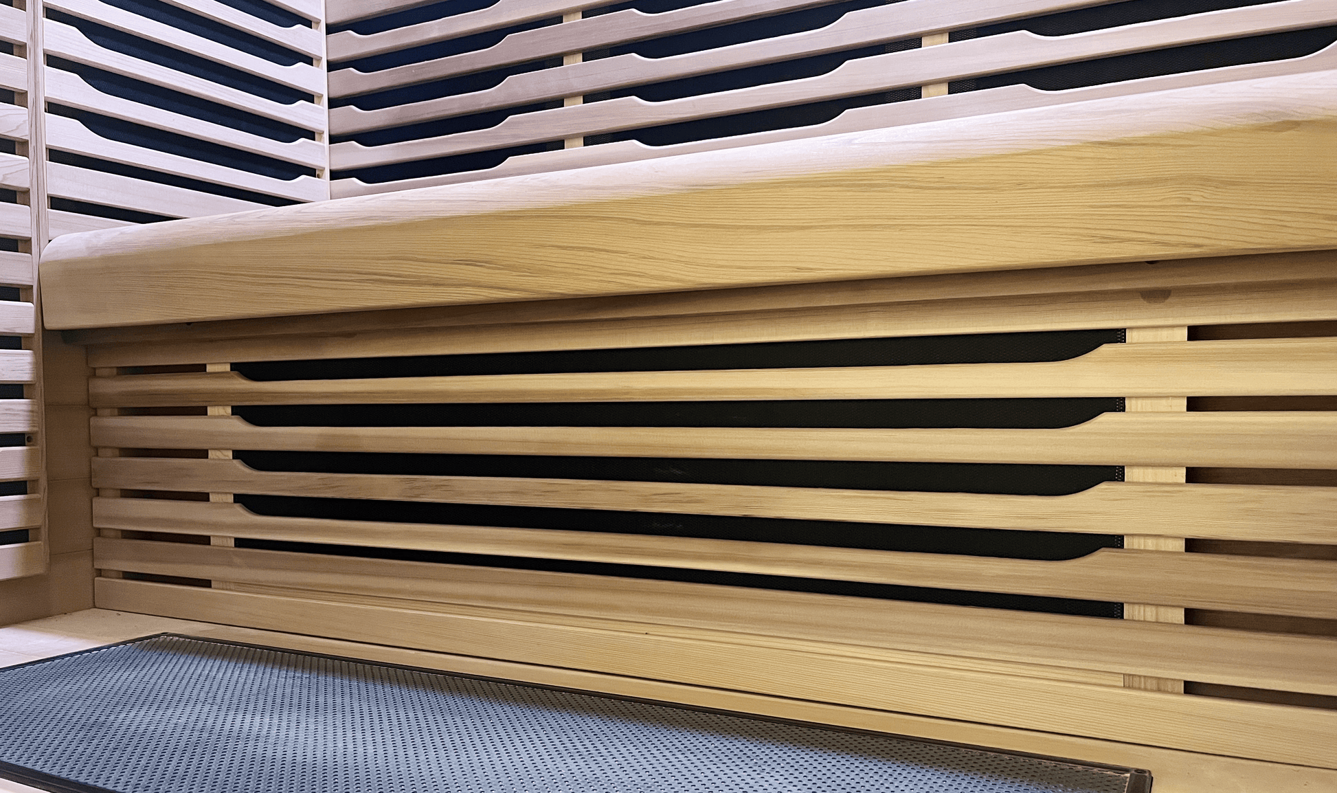 Under-bench view of Canadian Red Cedar wood in a Nook Ultra 3-person sauna