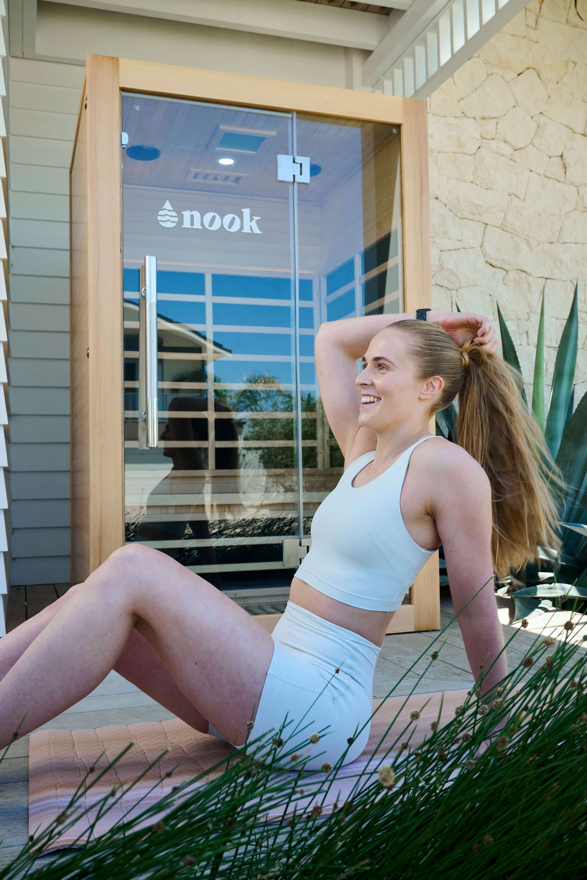 Individual infront of a Nook Elite 2-person infrared sauna